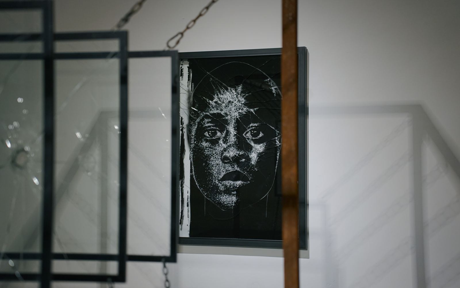 Broken glass face with chain sculpture